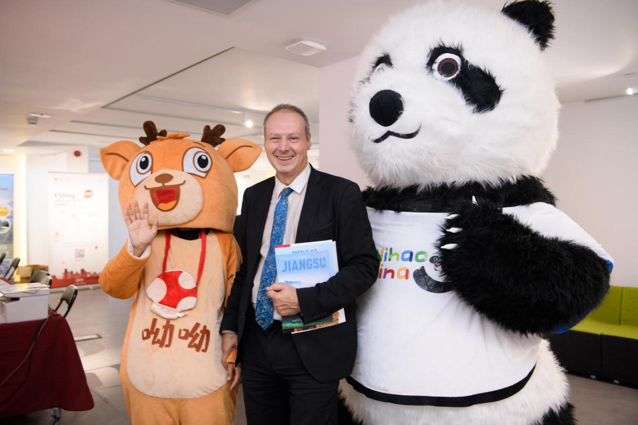 嘉宾与熊猫和麋鹿人偶合影。傅永山摄